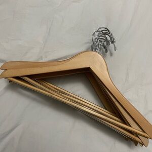 Eleven good quality wooden hangers with ribbed bar